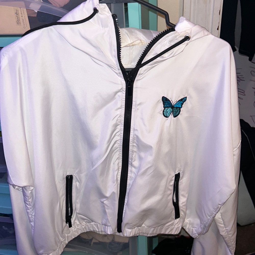 A white butterfly windbreaker jacket, size large